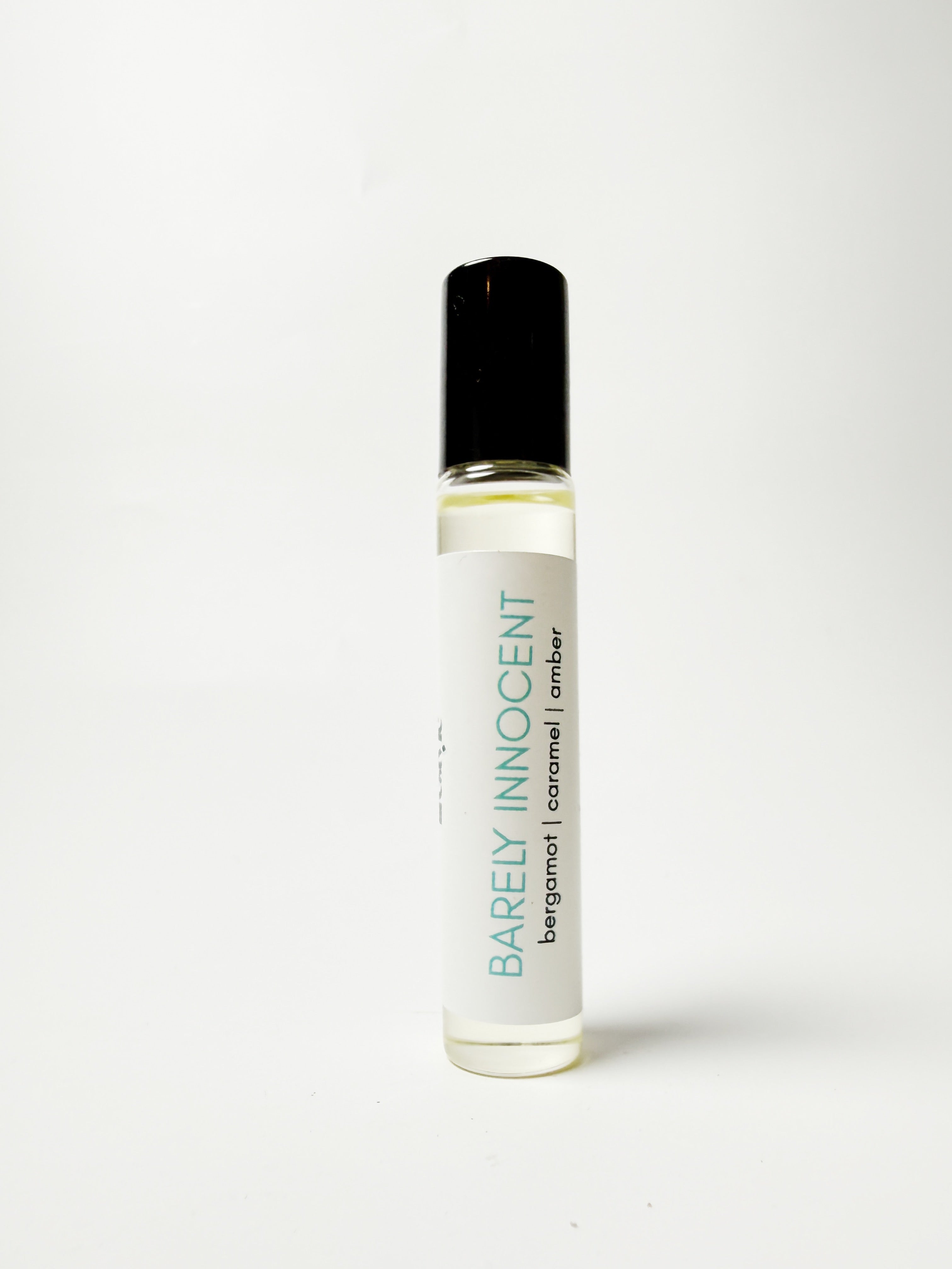 Roll-on bottle of 'Barely Innocent' perfume on a white background