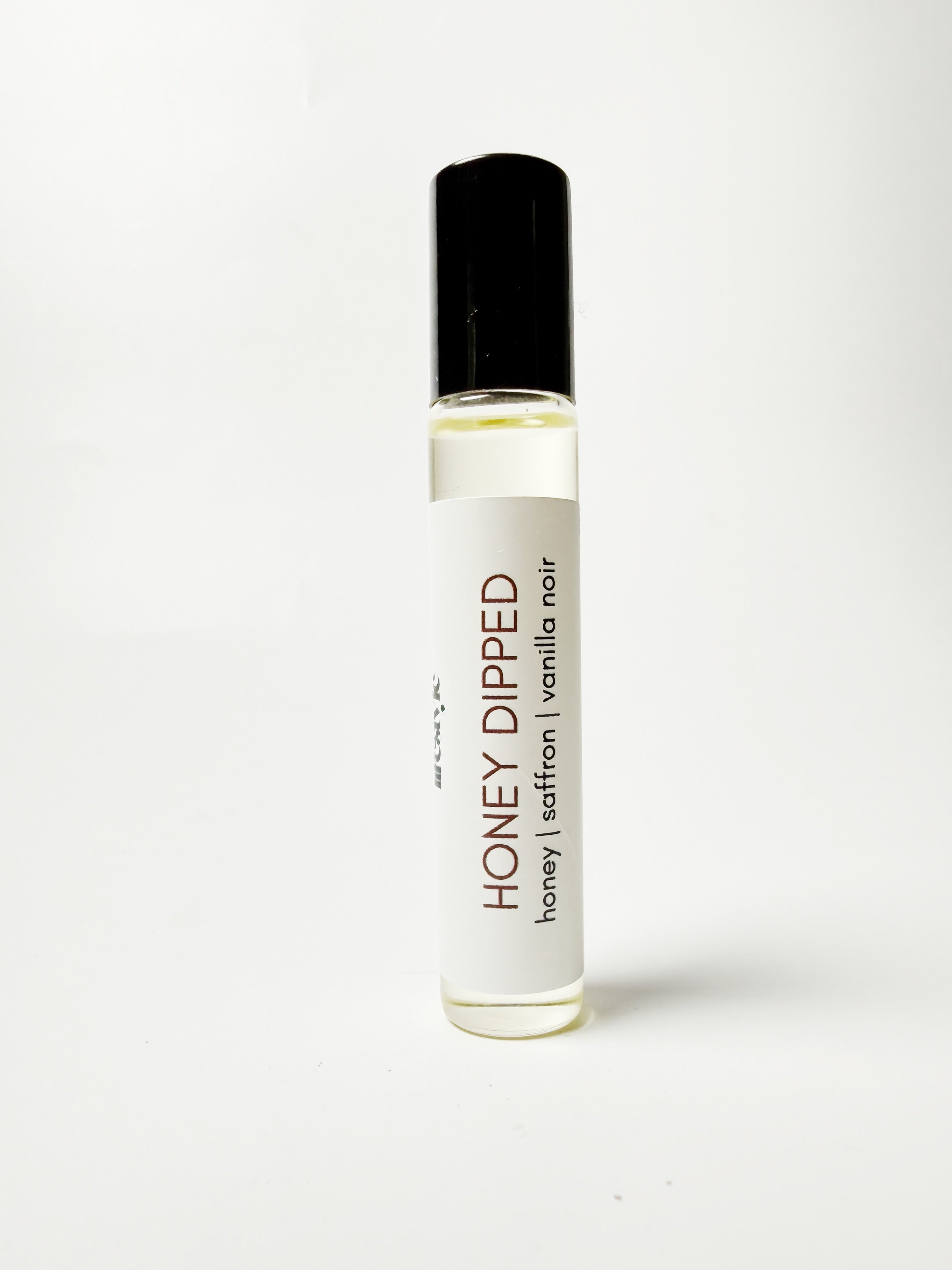Roll-on bottle labeled 'Honey Dipped' on a white background