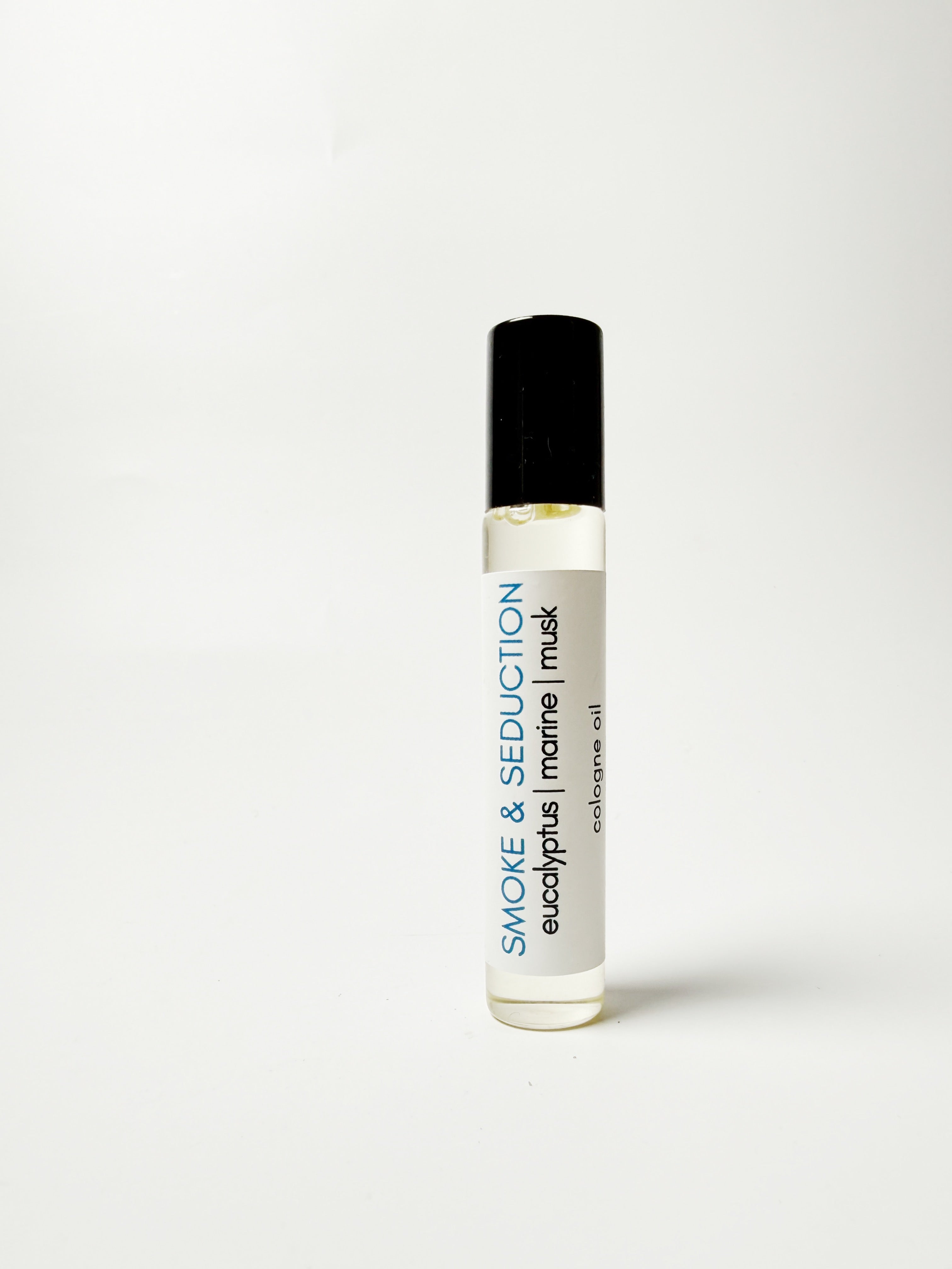 Roll-on bottle of 'Smoke & Seduction' cologne oil on a white background